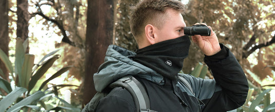 Winter scene of camping and mountaineering featuring MCTi Winter Neck Gaiter with Elastic Closure, functioning as a face mask to keep warm in early morning winter conditions.