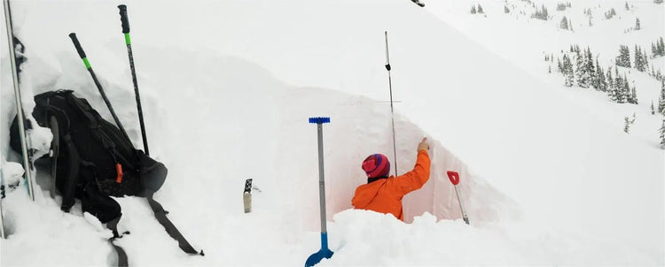 Snow stability testing: Individual digging a snow pit to assess conditions and safety