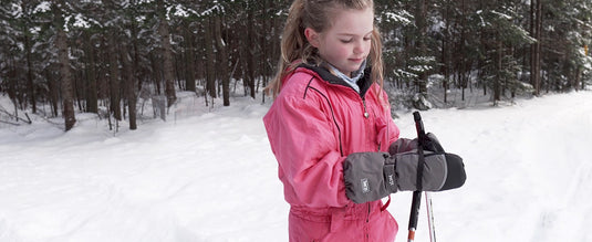 Little girl wearing MCTI Kids Mittens with String, holding a ski pole for winter fun